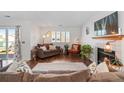 Bright and open living room featuring a cozy fireplace and hardwood floors at 8408 Everett Way # B, Arvada, CO 80005