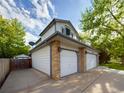 Exterior view of a home featuring a spacious three-car garage with brick accents and a well-manicured lawn at 2720 E 121St Pl, Thornton, CO 80241