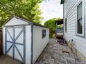 Backyard shed with a small window and a patio area featuring brick pavers at 2720 E 121St Pl, Thornton, CO 80241