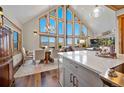 Open-concept dining room with vaulted ceilings, hardwood floors, and views at 538 Sawmill Creek Rd, Evergreen, CO 80439