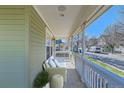 Inviting front porch featuring comfortable seating, perfect for relaxing and enjoying the neighborhood views at 9435 E 108Th Pl, Commerce City, CO 80640
