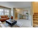 Bright living room with a comfortable couch, accent pillows, and stylish coffee table at 1865 Terry St # 3, Longmont, CO 80501