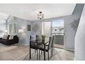 Modern dining area with black table and chairs, rug, and a view to the outside at 8500 E Jefferson Ave # 16B, Denver, CO 80237