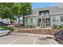 Charming condo complex with reserved parking, stone landscaping, and a welcoming entrance with stairs at 8500 E Jefferson Ave # 16B, Denver, CO 80237