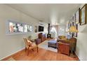 Comfortable living room with a wood-burning stove and hardwood floors at 26378 S End Rd, Kittredge, CO 80457
