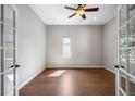Bright room showcasing hardwood floors, neutral walls, a ceiling fan, and window allowing natural light to illuminate the space at 4421 Tanager Trl, Broomfield, CO 80023