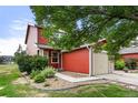 Beautiful home exterior with lush green grass, a walkway, and mature trees, creating a serene and inviting space at 351 Montgomery Dr, Erie, CO 80516