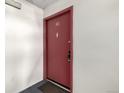 Entrance to unit 101 with red door and secure lock at 12131 Melody Dr # 101, Denver, CO 80234