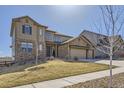 Handsome home with a stone and siding exterior, three-car garage, and drought-resistant landscaping at 9559 Yucca Way, Arvada, CO 80007