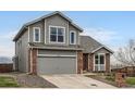 Charming two-story home featuring a brick and gray wood exterior with a two-car garage at 16645 W 2Nd Ave, Golden, CO 80401