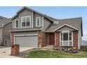 Charming two-story home featuring a brick and gray wood exterior with a two-car garage at 16645 W 2Nd Ave, Golden, CO 80401