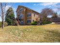 Expansive backyard with lush green grass and a multi-level deck at 9239 Erminedale Dr, Lone Tree, CO 80124