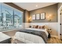 Cozy bedroom with a queen bed, window blinds, and wall art at 1756 Peak Loop, Broomfield, CO 80023