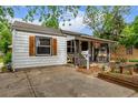 Cozy home with a covered front porch and well-maintained yard at 1341 Chester St, Aurora, CO 80010