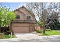 Charming two-story house with a brick facade, attached garage and well-manicured lawn with mature trees at 7900 E Dartmouth Ave # 75, Denver, CO 80231