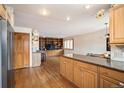 Open concept living space with built-in wooden shelving, hardwood floors, and adjacent to the kitchen area at 7900 E Dartmouth Ave # 75, Denver, CO 80231