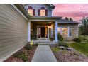 Inviting front porch with stylish columns and a cozy seating area at 20510 Oakbrook Ln, Parker, CO 80138