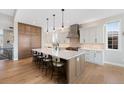 Modern kitchen with a large island, stainless steel appliances, and ample cabinet space at 32 Latigo Pl, Littleton, CO 80123