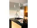 Modern kitchen island with granite countertops, stainless steel appliances, and designer lighting at 1133 14Th St # 2110, Denver, CO 80202