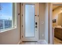 Bright foyer featuring tile floors, frosted glass door, and modern hardware at 1583 Grove St # 5, Denver, CO 80204