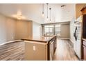 Kitchen island and stainless steel appliances with an open living area at 10176 Park Meadows Dr # 2403, Lone Tree, CO 80124