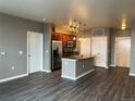 Open-concept kitchen featuring stainless steel appliances and a center island with a sink at 10176 Park Meadows Dr # 2403, Lone Tree, CO 80124