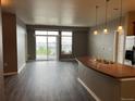 Bright living room featuring a kitchen island with a sink and a sliding glass door that leads to a balcony at 10176 Park Meadows Dr # 2403, Lone Tree, CO 80124