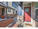 Inviting front porch with red door and decor at 1145 S Logan St, Denver, CO 80210