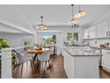 Bright kitchen featuring granite countertops, stainless steel appliances, and hardwood floors at 9606 Whitecliff Pl, Highlands Ranch, CO 80129