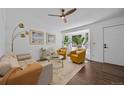 Bright living room featuring stylish decor, hardwood floors, and a cozy seating arrangement at 9606 Whitecliff Pl, Highlands Ranch, CO 80129