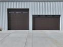 Garage doors with classic paneled design and ample concrete driveway space at 14550 Arfsten Rd, Larkspur, CO 80118