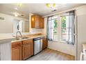 Functional kitchen with stainless steel appliances, wood cabinets, and plenty of natural light at 1545 S Ouray Cir # B, Aurora, CO 80017