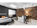 Cozy basement with a projector screen, exposed brick wall, and a seating area at 2560 Blake # 101, Denver, CO 80205