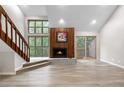 Bright living room features a wood fireplace, large windows, and access to a balcony at 701 Harlan St # E53, Lakewood, CO 80214