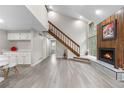 This living room boasts a fireplace, wood paneled wall, staircase, and plenty of natural light at 701 Harlan St # E53, Lakewood, CO 80214