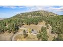 Scenic aerial view of a beautiful estate nestled among the trees at 20 W Ranch Trl, Morrison, CO 80465