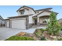 Charming two-story home with a covered porch, beautiful landscaping and stone accents at 16881 Roaming Elk Dr, Monument, CO 80132
