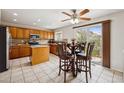 Bright kitchen featuring a dining table, central island, and stainless steel appliances at 12850 Ventana St, Parker, CO 80134