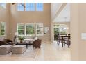 Bright and airy living room with high ceilings, large windows, and an adjacent dining area at 14278 Greenfield Loop, Parker, CO 80134