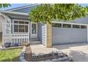 This charming home has an enclosed front porch with an attached two car garage at 17692 E Brown Cir, Aurora, CO 80013