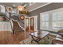 Elegant foyer with hardwood floors, staircase, and natural light from the windows at 7243 S Kellerman Way, Aurora, CO 80016