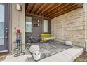 Cozy front porch features modern furnishings, a hanging swing, and decorative accents for relaxing outdoors at 5676 Emporia St, Denver, CO 80238