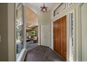 Grand entryway with hardwood door, stone floors, and living room view at 3251 Interlocken Dr, Evergreen, CO 80439