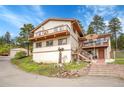 Two-story home with a balcony and outdoor patio with beautiful steps leading to the property at 9648 Yegge Rd, Morrison, CO 80465