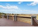 Spacious outdoor deck offering panoramic views of rolling hills and a serene landscape at 6743 Serena Ave, Castle Pines, CO 80108