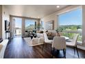 Bright living room featuring hardwood floors, modern furnishings, and large windows with scenic views at 20 Wilcox St # 410, Castle Rock, CO 80104
