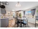 Bright dining area with a round table and a scenic view of the outdoors at 208 Wark Ave, Berthoud, CO 80513