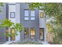 Contemporary townhome with a gray brick facade and wood fence at 2945 S Elati St, Englewood, CO 80110
