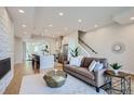 Open concept living area featuring a fireplace and modern kitchen at 2945 S Elati St, Englewood, CO 80110