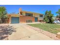 Side view of a two-story home with attached garage and driveway at 433 S Vaughn Way, Aurora, CO 80012